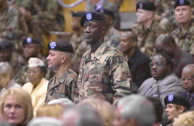 Brig. Gen. Abraham Turner, standing, at right, appears with Lt. Gen. Dennis Cavin on Friday as he waits to take command of Fort Jackson, the Army's largest training base, in Columbia.