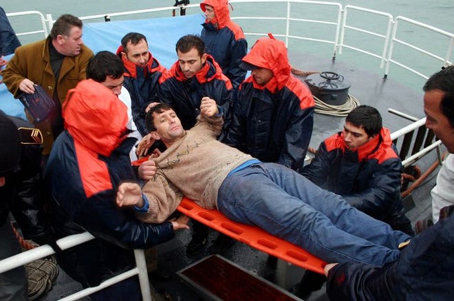An Albanian migrant is recovered in the Albanian
southwestern port of Vlora, 85 miles from Tirana on Saturday after he was rescued at sea as the speedboat he was trying to reach Italy on was shipwrecked.