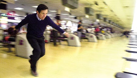 Democratic hopeful Rep. Dennis Kucinich bowls at Strikers East in Raymond during a campaign stop on Thursday.