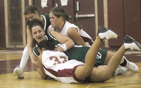 Portsmouth High School?s Brittany Bushman (33) ties up Dover?s Nikki Jenis during the Clippers? Class L victory on Friday.
Jay Reiter/photos@seacoastonline.com