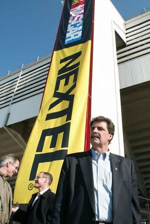 NASCAR President Mike
Helton stands in front of the new Nextel banner during the UAW-GM Motorsports Media Tour on Monday.