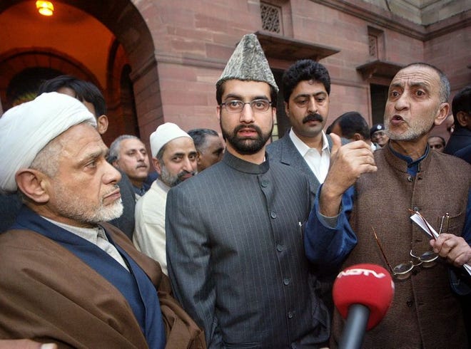 Abdul Ghani Bhat, right, talks to members of the media as Umar Farooq, center, and Bilal Ghani Lone, left, other leaders of the All Parties Hurriyat Conference, a separatist umbrella group, look on, after their meeting with Indian Deputy Prime Minister Lal Krishna Advani in New Delhi, India, Thursday.