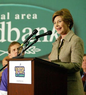 First lady Laura Bush kicks off the 2004 Souper Bowl of Caring Thursday at the Capital Area Food Bank in Washington. She is joined by the Rev. Brad Smith, founder and director of the Columbia, S.C.-based organization.