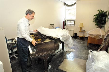 Mark DeTurk, chairman of the music department at the University of New Hampshire, looks at the water damage in Jenni Cook?s studio at the Paul Creative Arts Center in Durham on Thursday. Frozen water pipes burst during last weekend?s cold weather.Rich Beauchesne/rbeauchesne@seacoastonline.com