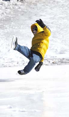 Brandon Johnson, 8, goes flying off his feet after he attempted to skate down the hill at the Kittery Winter Festival.