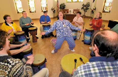 Linda Brown, a nurse at Wesbury United Methodist Retirement Community, in Meadville, Pa., dances to the beat provided by co-workers during a drum circle jam session on Jan. 21.