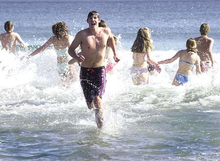 Alex Johanson runs out of the ocean after plunging (briefly) into it at Long Sands in York Beach Saturday. He was one of about 30 Interact Club members who held a polar plunge to raise money for the Make-A-Wish Foundation. Interact is sponsored by the York Rotary Club.