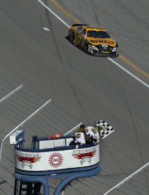 Defending NASCAR champion Matt Kenseth takes the checkered flag to win the UAW-DiamlerChrysler 400 on Sunday at the Las Vegas Speedway.