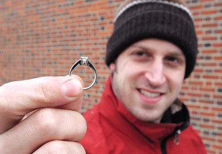 Charlie Bryon, 28, of Dover, holds the engagement ring he had given to his fiancee, who lost it outside the Bank of New Hampshire on Wednesday morning. Bryon and employees of the bank searched the snow-covered area and finally found the diamond set in white gold. He and his bride-to-be will be married in July.
Deb Cram/dcram@seacoastonline.com