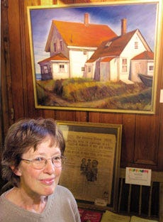 Janet Carlson stands with her oil on canvas "Monhegan Museum" that won best in show at the Seacoast Artists Association Annual Winter Awards.