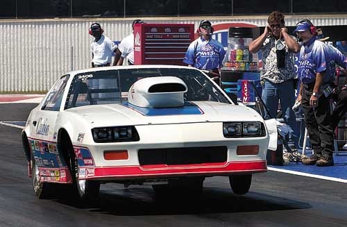 Jacksonville's Steve Schumacher does a wheel stand in Caution, his 1990 Chevy Camaro, at the starting line at Thursday's Gatornationals Super Comp races.