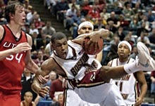 Boston College's Craig Smith, center, is pulled down by Utah's Tim Frost during second half action of yesterday's St. Louis Regional.