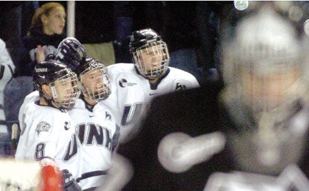 UNH forward Steve Saviano (8) celebrates a goal with teammates during the Wildcats' Hockey East quarterfinal series against Providence earlier this month. Third-seeded UNH plays No. 2 Michigan in the Northeast Regional semifinals on Saturday at Manchester's Verizon Wireless Arena.
Jackie Ricciardi/jricciardi@seacoastonline.com