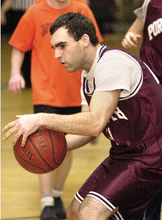 Anthony Hibble, playing for Team Portsmouth, works the ball down the court during the New Hampshire Special Olympics Basketball Tournament at Portsmouth High School on Sunday.