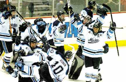 Memers of the University of Maine hockey team celebrate their 2-1 overtime victory over Wisconsin in Saturday's NCAA East Regional final. The win gave the Black Bears a berth in the Frozen Four for the fourth time in six seasons.AP photo