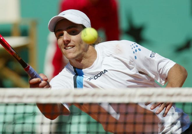 French Open champion Gaston Gaudio of Argentina returns the ball to compatriot Guillermo Coria. Gaudio won, 0-6, 3-6, 6-4, 6-1, 8-6.
