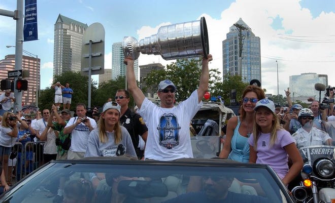 The Tampa Bay Lightning's Dave Andreychuk holds the Stanley Cup while riding in a Tampa parade held Wednesday in honor of the team's victory over the Calgary Flames in the Stanley Cup finals.