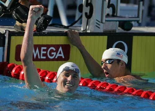 Aaron Peirsol, left, celebrates his world-record finish in the men's 200 meter backstroke as Michael Phelps looks on.
