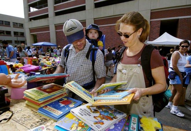 David and Jennifer Cover and their son Jake, 2, look for children's books at the Parent Connection Swap Meet held in the parking lot of Scripps Memorial Hospital in La Jolla, Calif., on June 27.
