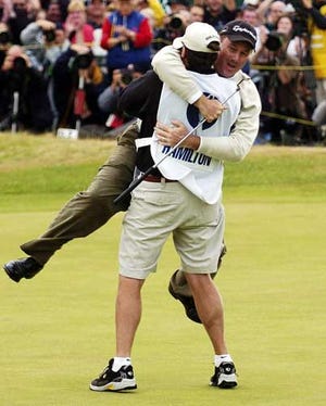 Todd Hamilton runs to caddie Ron Levin after winning the British Open at Royal Troon golf course in Scotland on Sunday.