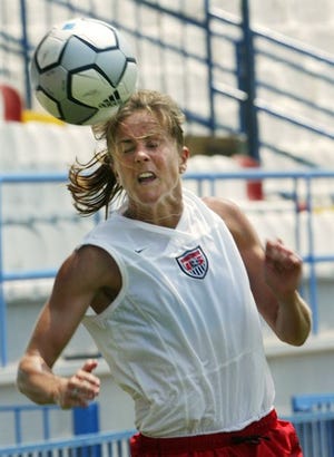 Brandi Chastain heads the ball Thursday during the women's U.S. Olympic team's training session in Athens.