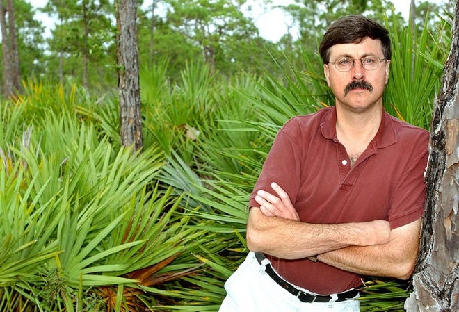 Andrew Eller, a 17-year U.S. Fish and Wildlife Service biologist, stands among saw palmetto in Hobe Sound on Friday. Frustrated with what he considered internal apathy, Eller went public in May, claiming that the agency intentionally minimized habitat needs for the endangered cat to make more acreage available for development. He is now losing his job.