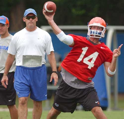 Florida quarterback coach Ed Zaunbrecher watches backup quarterback Justin Midgett throw a pass in the later stage of workouts Monday during Florida's first practice for the fall.