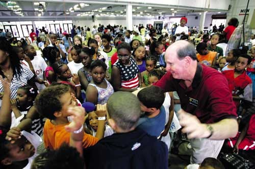 State Attorney Bill Cervone instructs children about gun safety and what to do if they find a firearm Saturday during the 5th annual Stop the Violence Rally at the Alachua County Fairgrounds Exhibition Hall.
