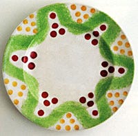 Folk art green spatter plate, with red and yellow Christmas balls valued at $8,000-$10,000.