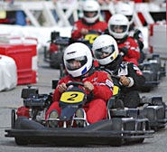 An E.J. Jaxtimer Builders driver leads other Formula One carts during the Seaside LeMans race yesterday at Mashpee Commons.