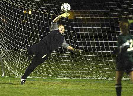 Raymond goalkeeperj Lindsey Fickett makes a leaping save against Hopkinton in the Class M girls soccer championship game.