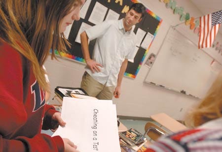 Seventh-grader Emily Mayotte participates in an activity organized by Ben Clapp (in back), the coordinator at Cooperative Middle School in Stratham. The activity, which targeted how one's behavior affects other people and themselves, was prompted by the novel, "The Outsiders," which the students are reading..