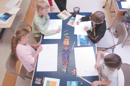 Newington School students, clockwise, from left, Rachel Merchant, Alex Taylor, Evan Anderson and Kelsey Frizzel work on their weather posterts to submit in the Weather Channel's national poster contest.