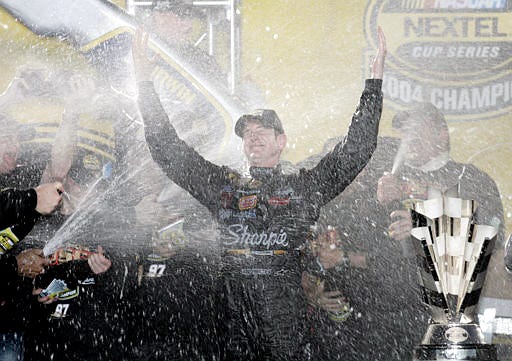 Kurt Busch is showered in champagne after winning the Nextel Cup Champioship on Sunday in Homestead.