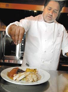 Jacques Desire Moonsamy, chef at The Metro restaurant in Portsmouth, says his Thanksgiving meal includes honey, cinnamon and cloves in the cranberry sauce and spices from his homeland of Mauritius.