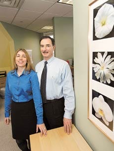 Lisa and Ed Ganem, owners of Home Instead Care in Portsmouth, stand in their office. The company enables elderly clients to live independently with one-on-one assistance with everyday living needs.