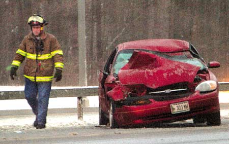 A York, Maine, firefighter walks near the scene of a two-car accident that occured at 3:#0 p.m. on the southbound side of Interstate 95 in York, Maine.