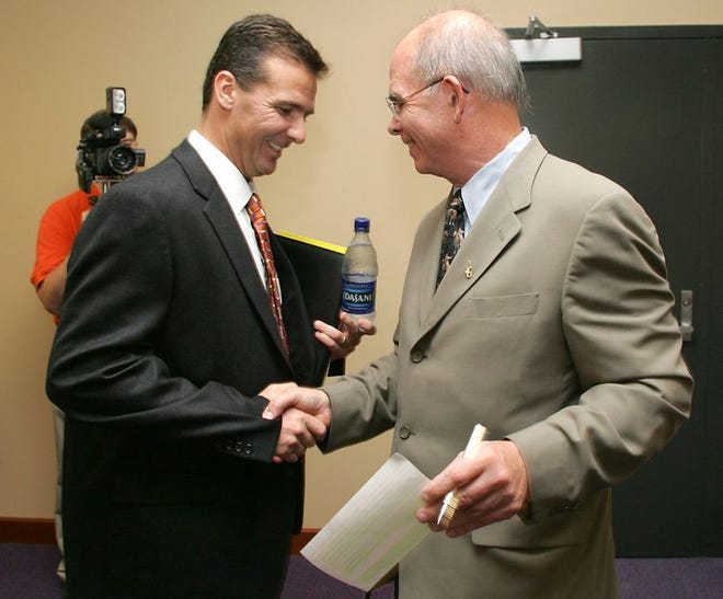 University of Florida President Bernie Machen, right, greets new head football coach Urban Meyer on Tuesday.