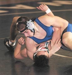Winnacunnet High School's Greg Tirrell (top) takes down Manchester Central's Ben Champagne during high school wrestling action on Wednesday.