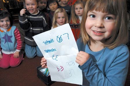 Five-year-old Maddie McKie shows the current tally of toothpaste and toothbrushes she and her classmates have collected at Jack and Jill Nursery School in York Friday morning. Maddie began the project in an effort to help children in Africa.