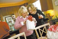 Leslie Cahill, left, checks out the contents of some bags of cookies with Joan Bittner. Knight Ridder Tribune photo