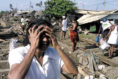 An unidentified woman cries after tidal waves destroyed her house on the coastal areas in Colombo, Sri Lanka, Sunday, Dec. 26, 2004. Massive waves triggered by earthquakes crashed into villages along a wide stretch of Sri Lankan coast on Sunday, killing more than 2,100 people and displacing a million others.
AP Photo/Eranga Jayawardena