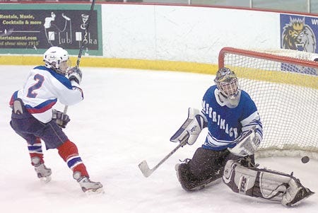 Winnacunnet's Sam Auffant (left) watches as his shot goes wide of the net against Marrimack on Wednesday.