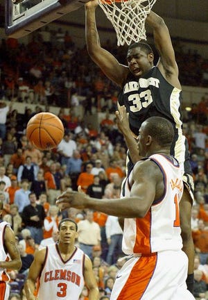 Wake Forest forward Trent Strickland (33), a former standout at East Henderson, dunks over Clemson's Olu Babalola as the Tigers' Vernon Hamilton looks on in Saturday's game.