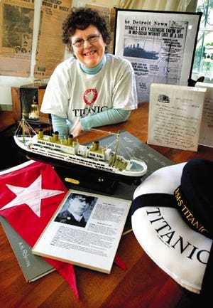 Mary Christopherson collects Titanic memorabilia, from old newspaper clips to movies. The front page of The Detroit News, seen in the background, erroneously reported that all passengers had been rescued before the Titanic sank.