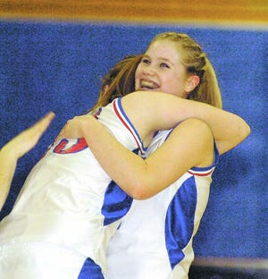 OYSTER RIVER’S HAYLEY JANELLE, right, gets a hug from teammate Emily Jasinski following Wednesday night’s 41-32 Class I semifinal victory over John Stark at Southern New Hampshire University in Manchester.