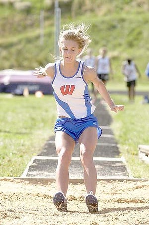 West Henderson's Sarah White lands in the sand pit while competing in the long jump during Thursday's girls portion of the WHKP Relays at North Henderson.