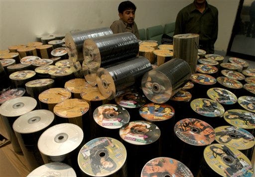 Confiscated compact discs are on display for media at the Pakistan's Federal Investigation Agency office in Karachi, Pakistan, Tuesday. FIA confiscated about one hundred thousand CDs in raids. Pakistan, China, India, Indonesia, and the Philippines lead a blacklist of Asian copyright violators released by the United States, which sought tough action to combat piracy and counterfeiting of U.S. goods.