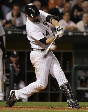 Chicago's Paul Konerko slaps a two-run single in the seventh inning to give the White Sox the lead against Baltimore.