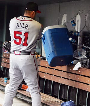 Atlanta relief pitcher Dan Kolb knocks over a water cooler in the dugout after he was pulled from the game in the ninth inning of the Braves' 6-5 loss to Colorado on May 11.